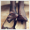 Slender nylon feet dipping worn leather flats